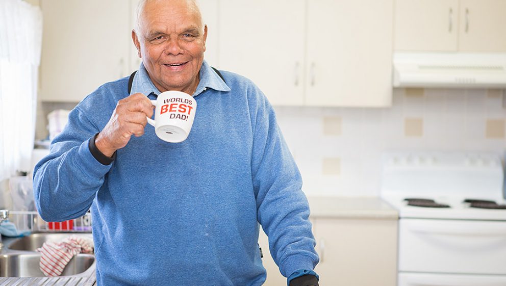Financial resilient man drinking tea in kitchen