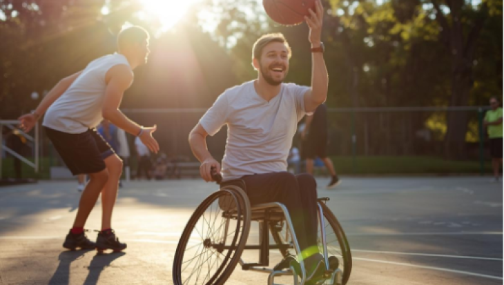 Man in wheel chair playing basketball